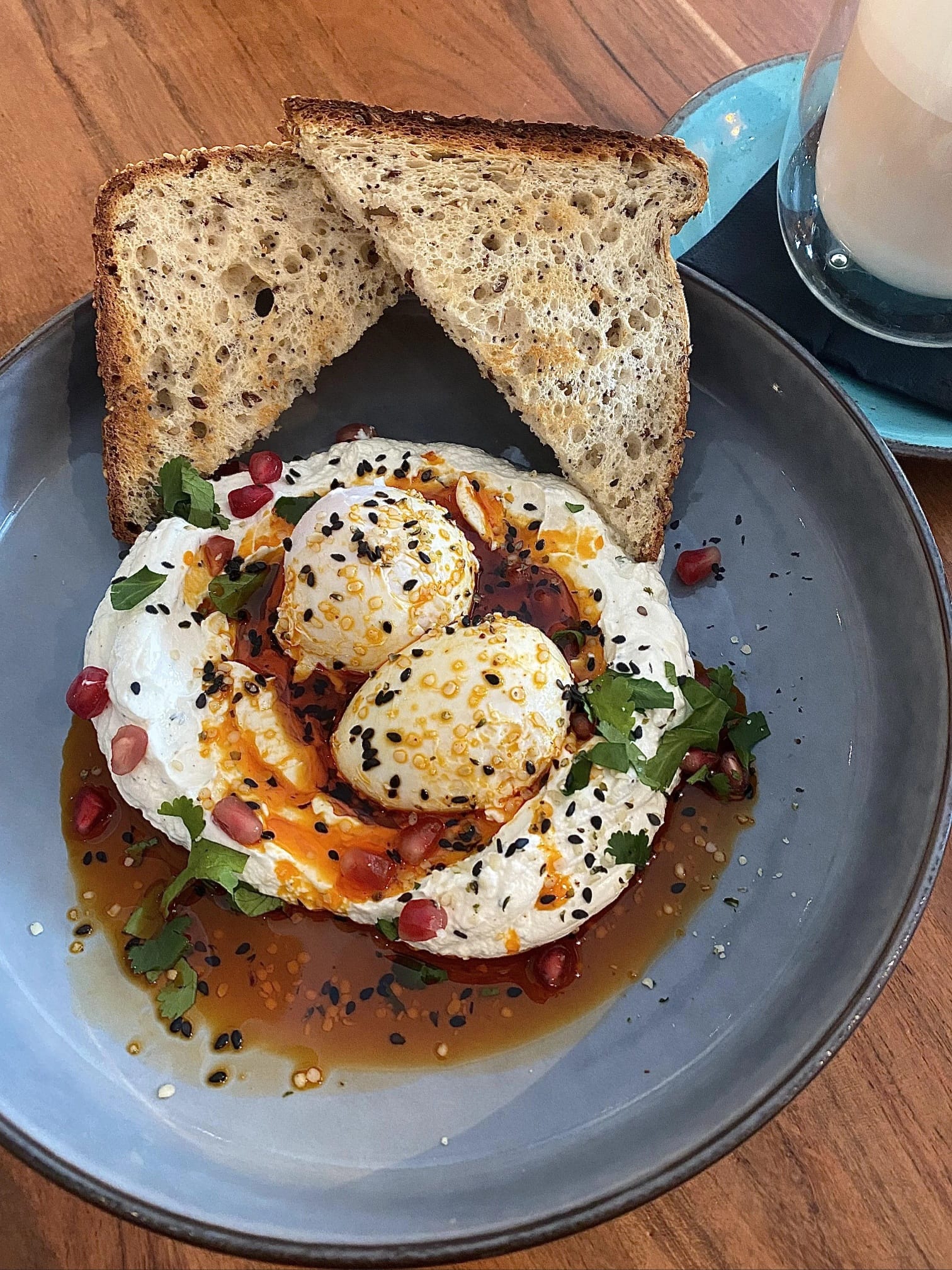 Poached eggs with yogurt, bread and chili oil
