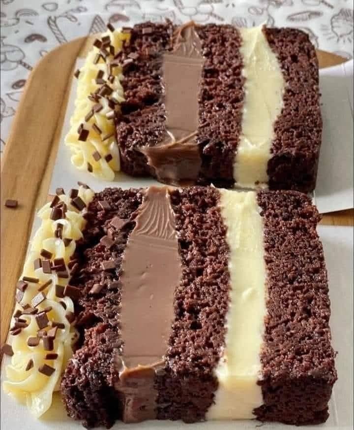 Layered chocolate cake with creamy filling and ganache